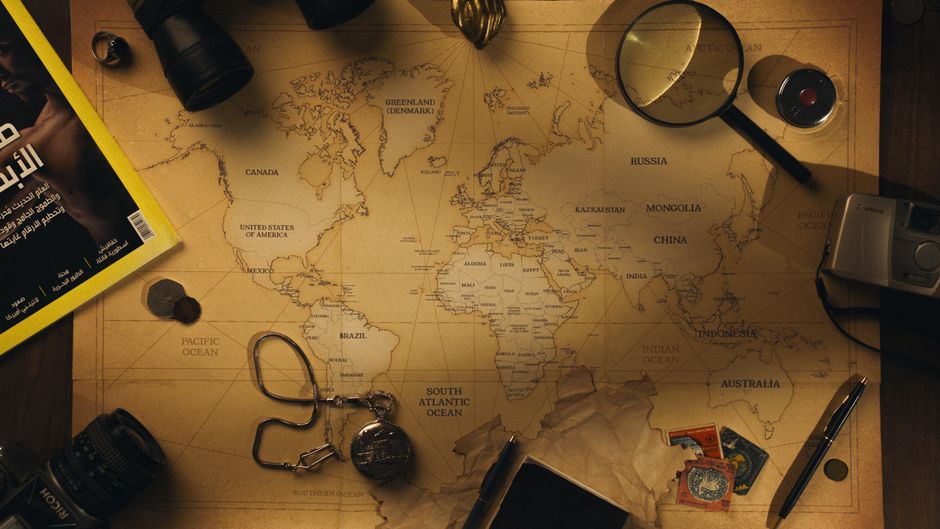 Flatlay of exploration tools and a vintage world map, capturing the essence of adventure.
